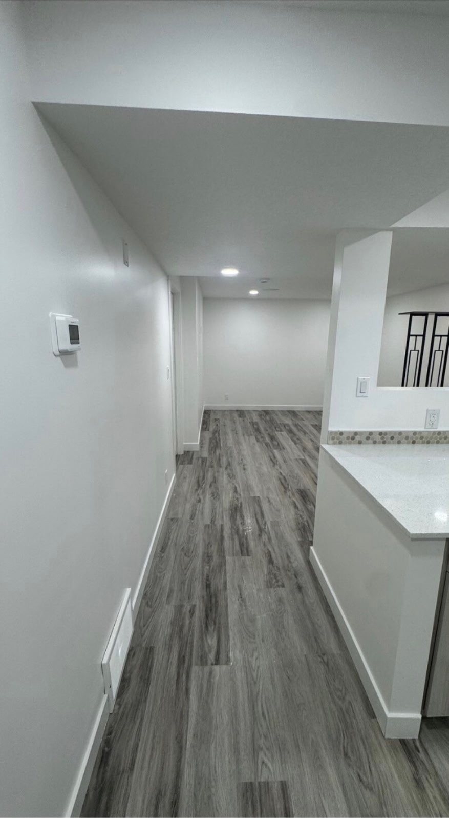 Calgary basement secondary suite hallway with its own thermostat by Timeless Interiors Ltd
