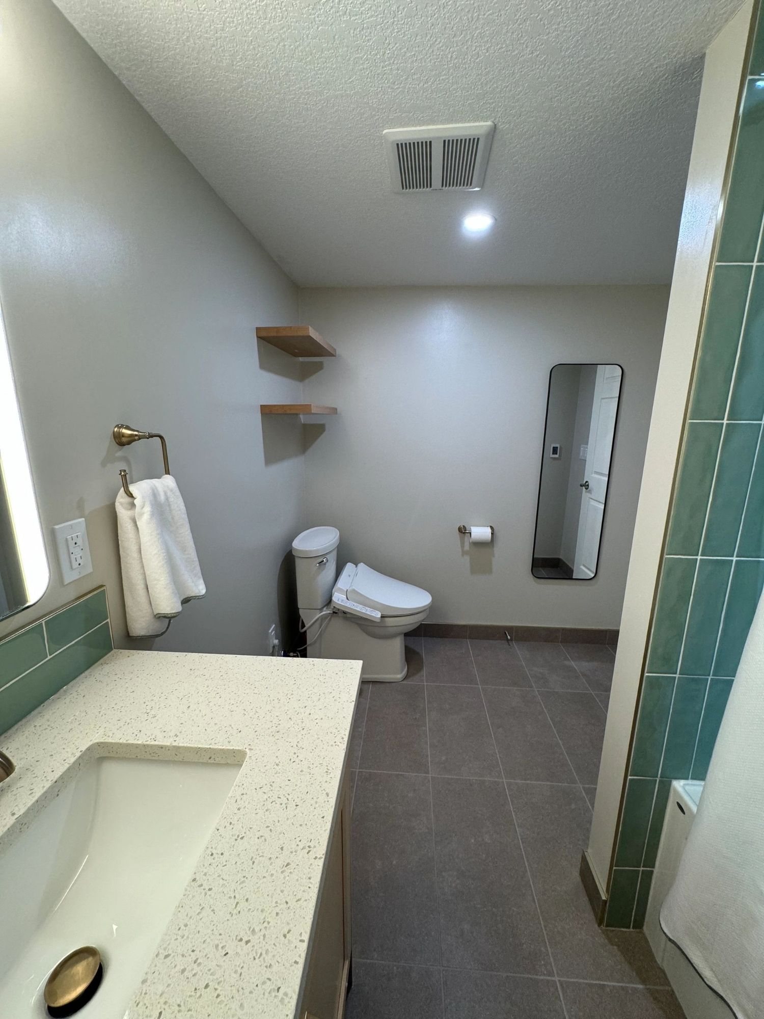 Calgary bathroom renovation with sage green stacked tile, quartz vanity top and walk-in shower by Timeless Interiors Ltd