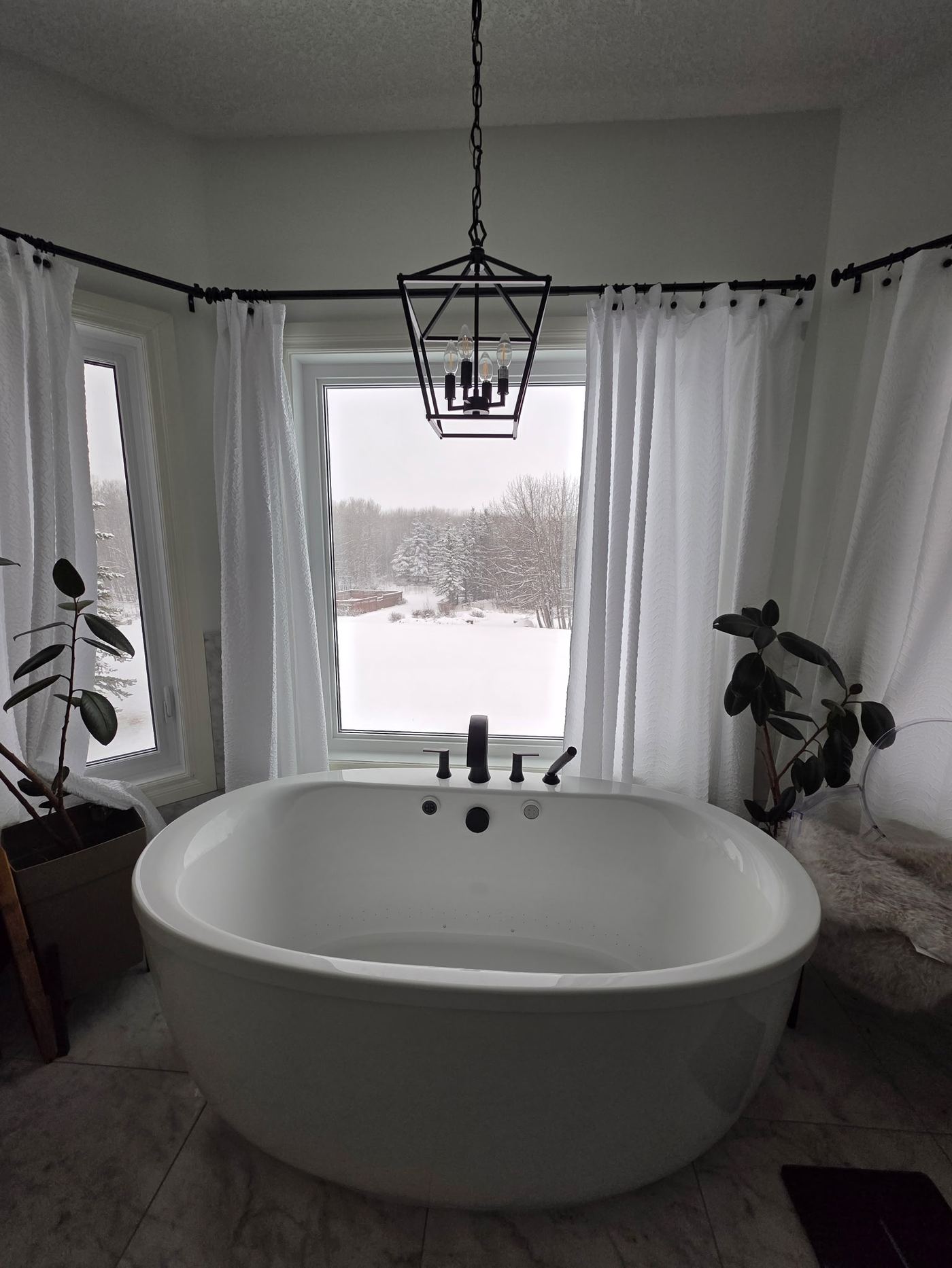 Freestanding soaker tub in a completed Calgary bathroom renovation by Timeless Interiors Ltd.