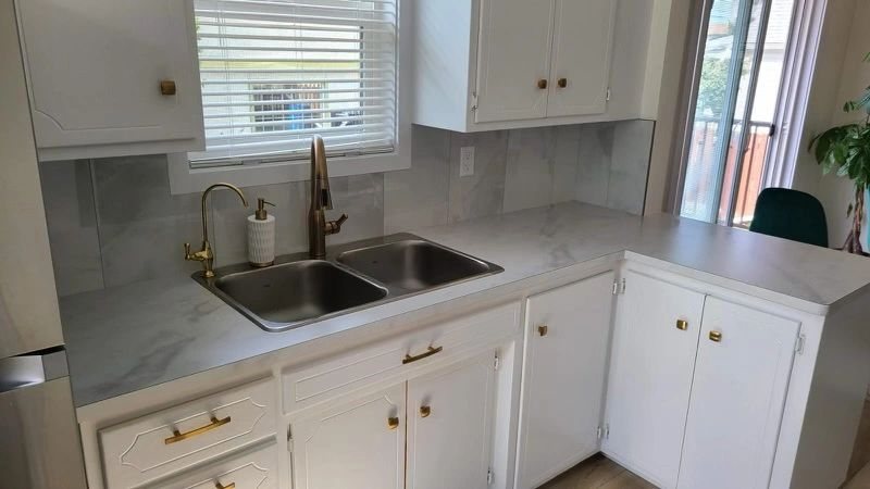 Calgary kitchen cabinet refinishing with white painted cabinets and brushed gold hardware by Timeless Interiors Ltd